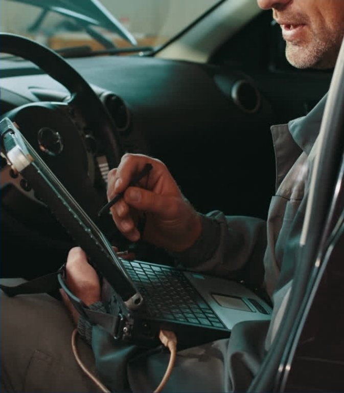 Peter Bradshaw completing a vehicle inspection on a tablet